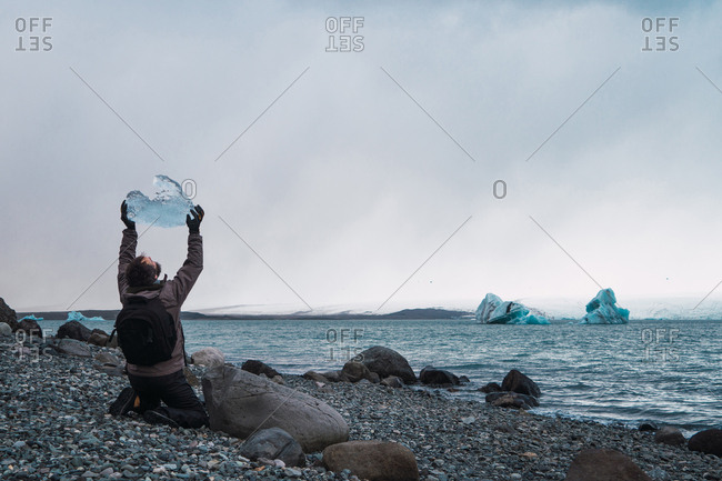 Cheerful man with piece of ice