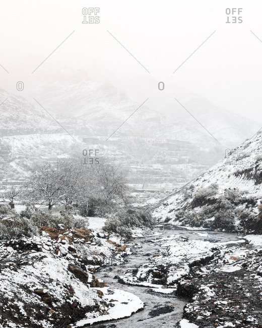 Frozen lake surrounded by Atlas Mountains in Morocco