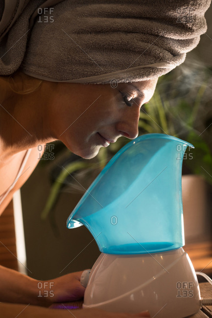 Pregnant woman using spa steam inhaler