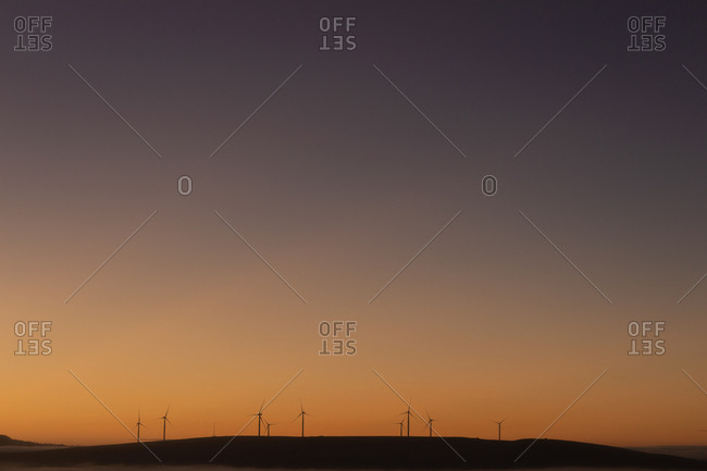 Wind mills at a wind farm during dusk