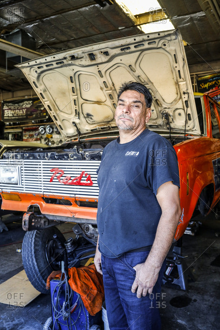 Route 66, New Mexico - June 19, 2018: Car mechanic posing in garage