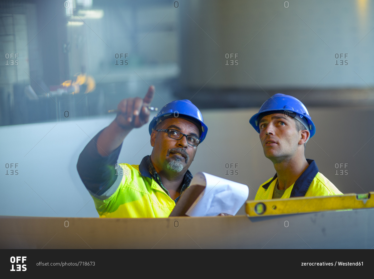Engineers in industrial plant discussing work