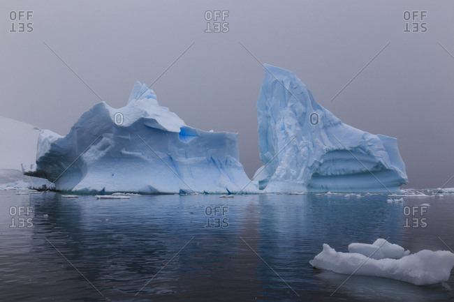 Blue icebergs in snowy weather, from sea level, Waterboat Point, Paradise Bay, Graham Land, Antarctic Peninsula, Antarctica, Polar Regions
