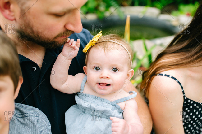 Close up of baby surrounded by family