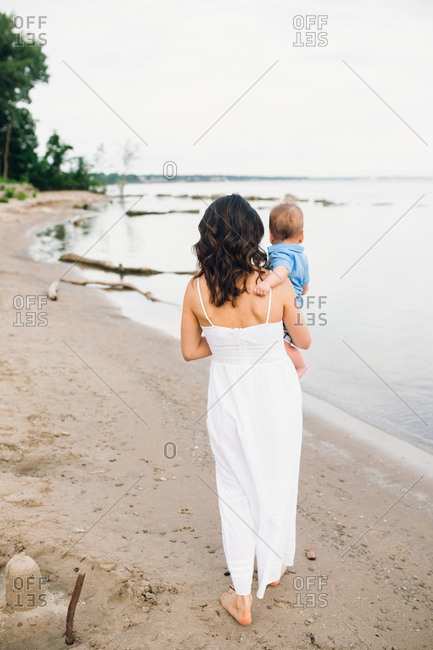 Mother walking with baby on beach