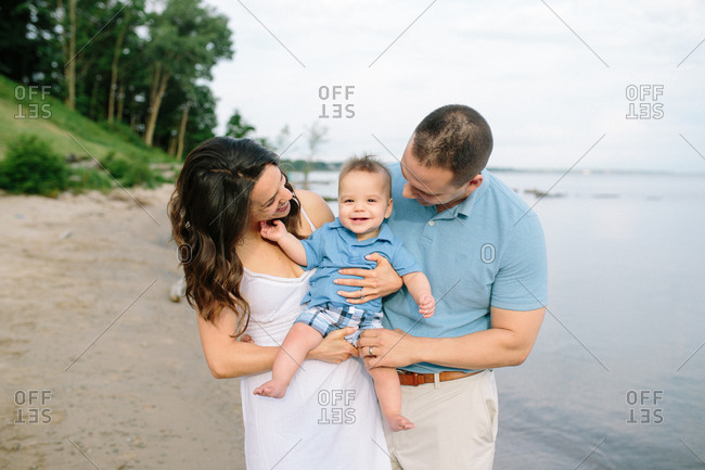 Close up of happy mother holding baby boy outdoors