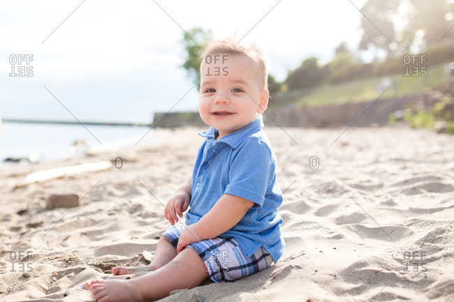 Baby sitting in sand on a beach