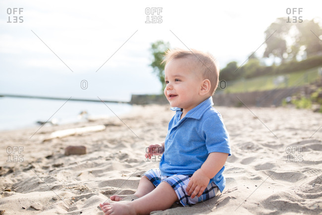 Happy mother holding baby boy on a beach