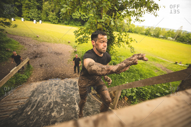 Fit men training over obstacle course at boot camp
