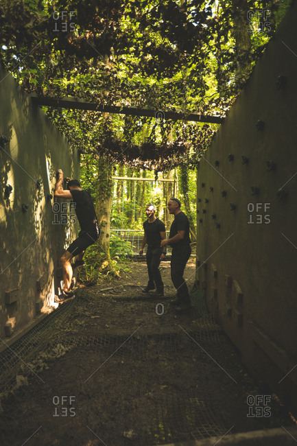Fit man training over obstacle course at boot camp