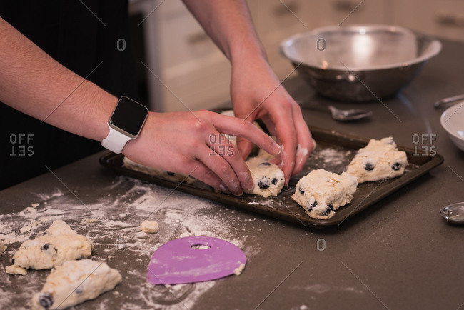 Woman preparing patties in kitchen at home