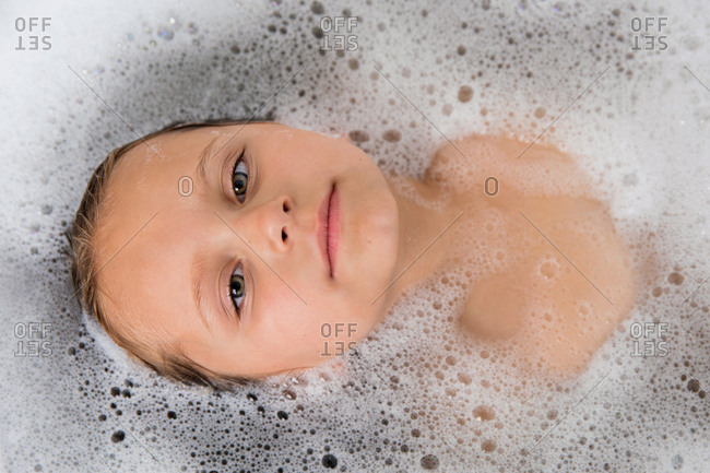 Overhead view of young girl in a soapy bubble bath