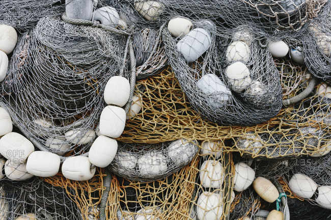 Fishing nets and floats, commercial fishing equipment in a heap on a quayside