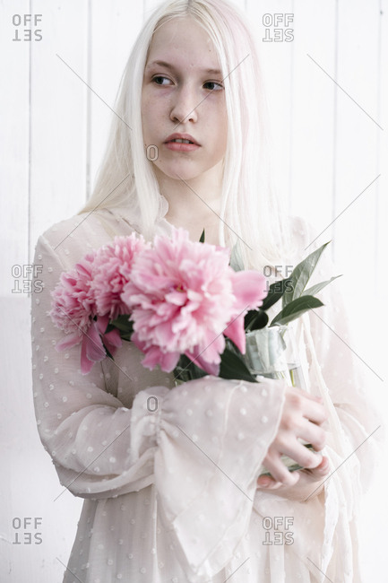 Woman With Bleach Blonde Hair Holding Pink Flower Stock Photo Offset