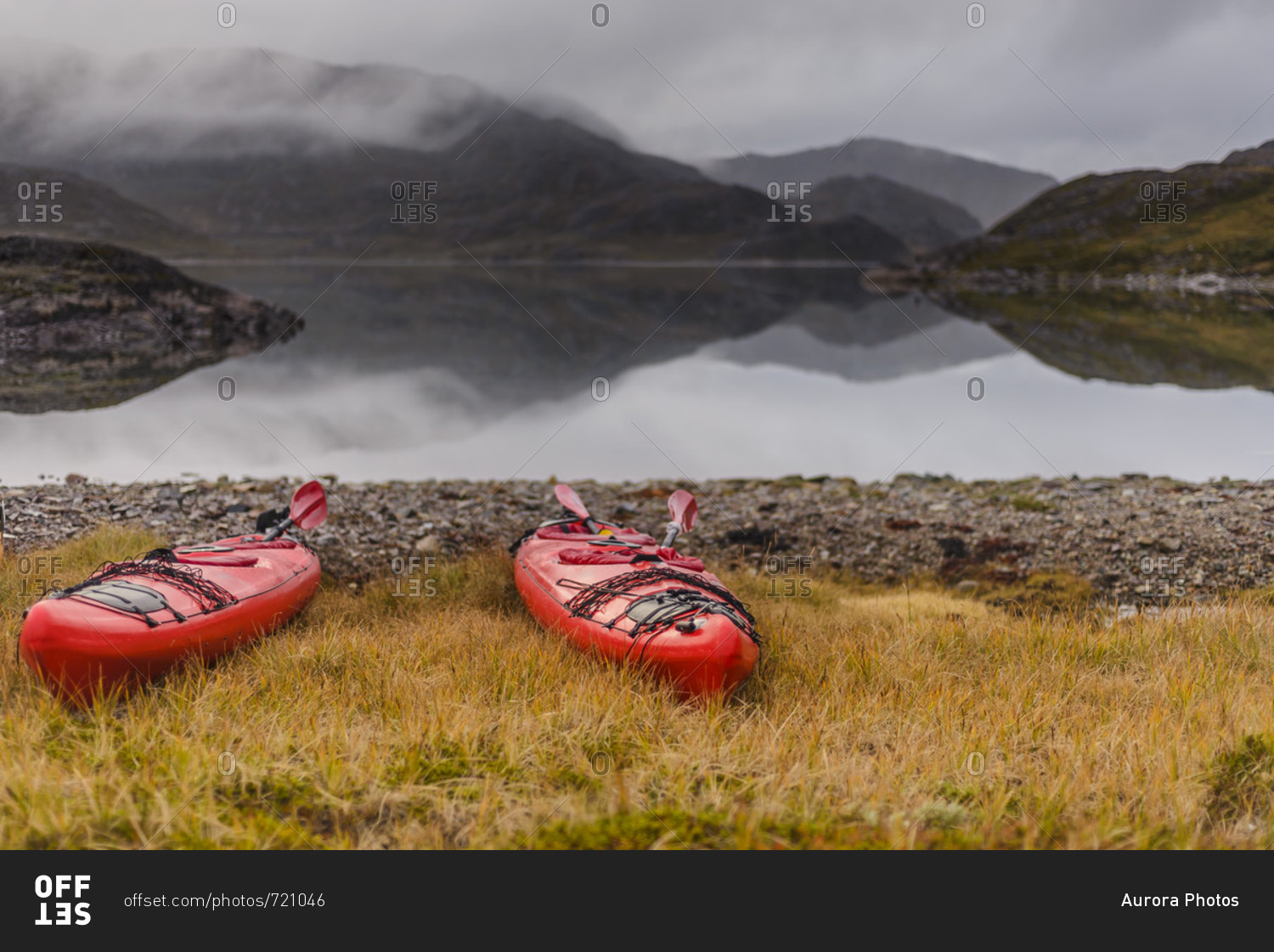 Two kayaks on shore of fjord during tour with Tasermiut Expeditions,  Narsaq, Greenland stock photo - OFFSET