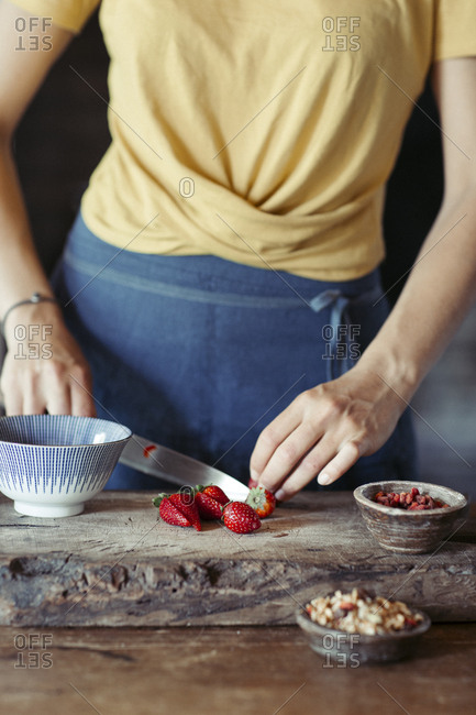 Woman preparing cutting strawberries on cutting board