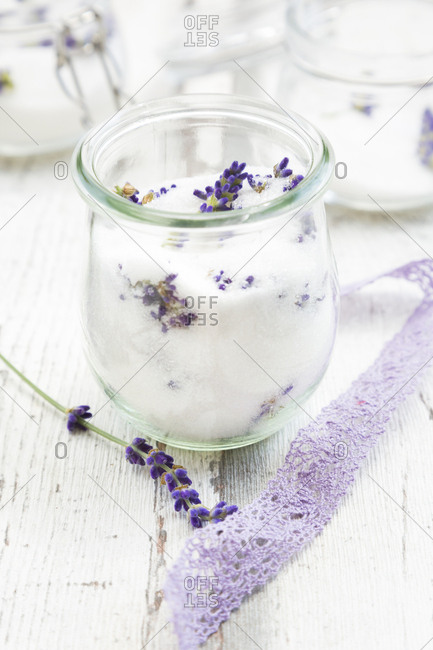 Glass of homemade lavender sugar with lavender blossoms