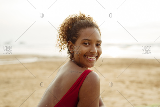 Pretty black girl portrait on the beach at sunset