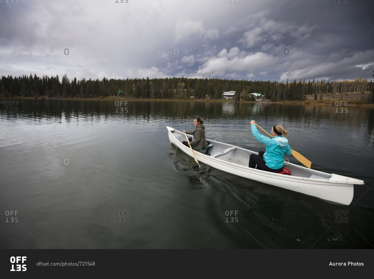 Two women canoeing on Lac Le Jeune, Kamloops, British Columbia, Canada
