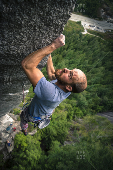 Adventurous rock climber climbing challenging cliff, Squamish, British Columbia, Canada