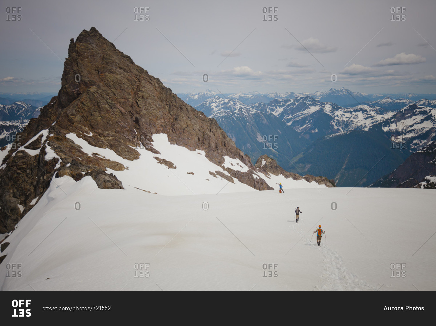 Distant view of three climbers approaching Foley Peak in the North