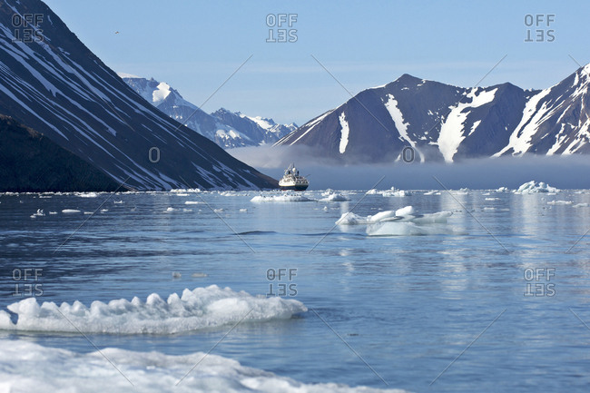 Clearing fog, icebergs, and passenger ship.