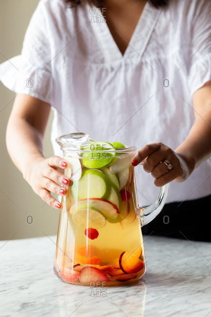 Woman making white sangria