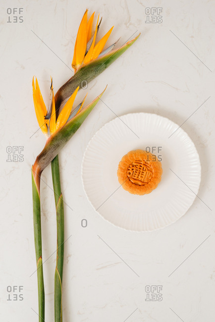 Vietnamese Mid-Autumn Festival moon cake with bird of paradise flowers