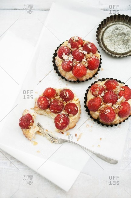 Mini sponge cakes topped with custard and strawberries