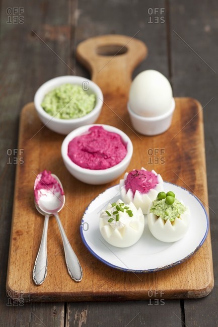 Boiled eggs with three dips: beetroot dip, horseradish dip and pea dip