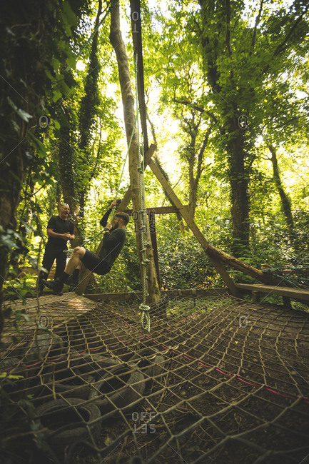 Fit men training over obstacle course at boot camp