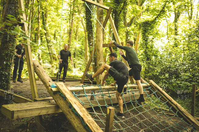 Fit men training over obstacle course at boot camp