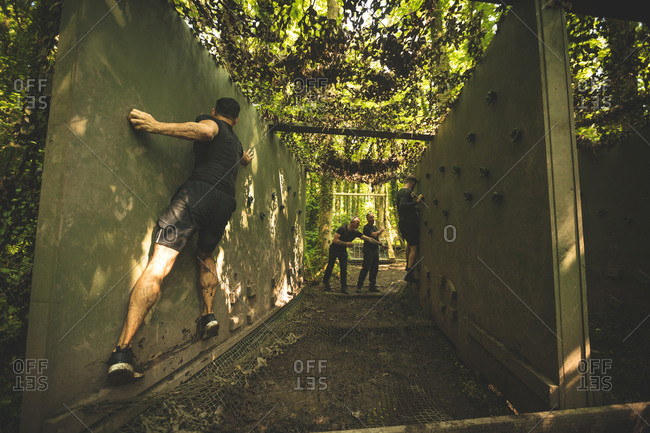 Fit men training over obstacle course at boot camp
