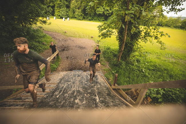 Fit men training over obstacle course at boot camp