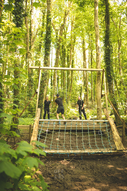 Fit men training over obstacle course at boot camp