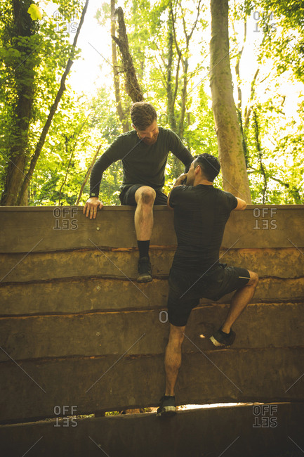 Fit men training over obstacle course at boot camp