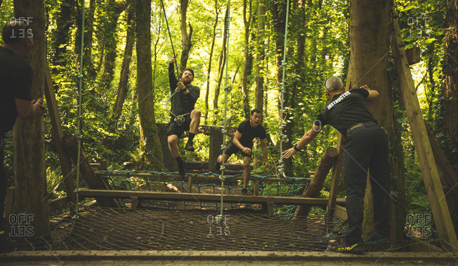 Fit men training over obstacle course at boot camp