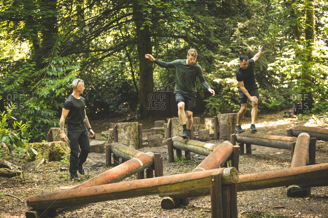 Fit men training over obstacle course at boot camp