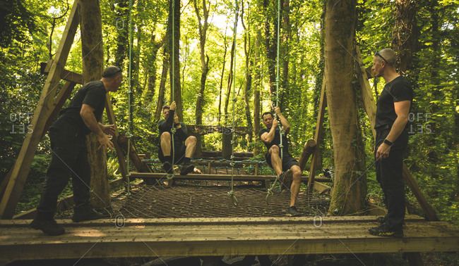 Fit men training over obstacle course at boot camp