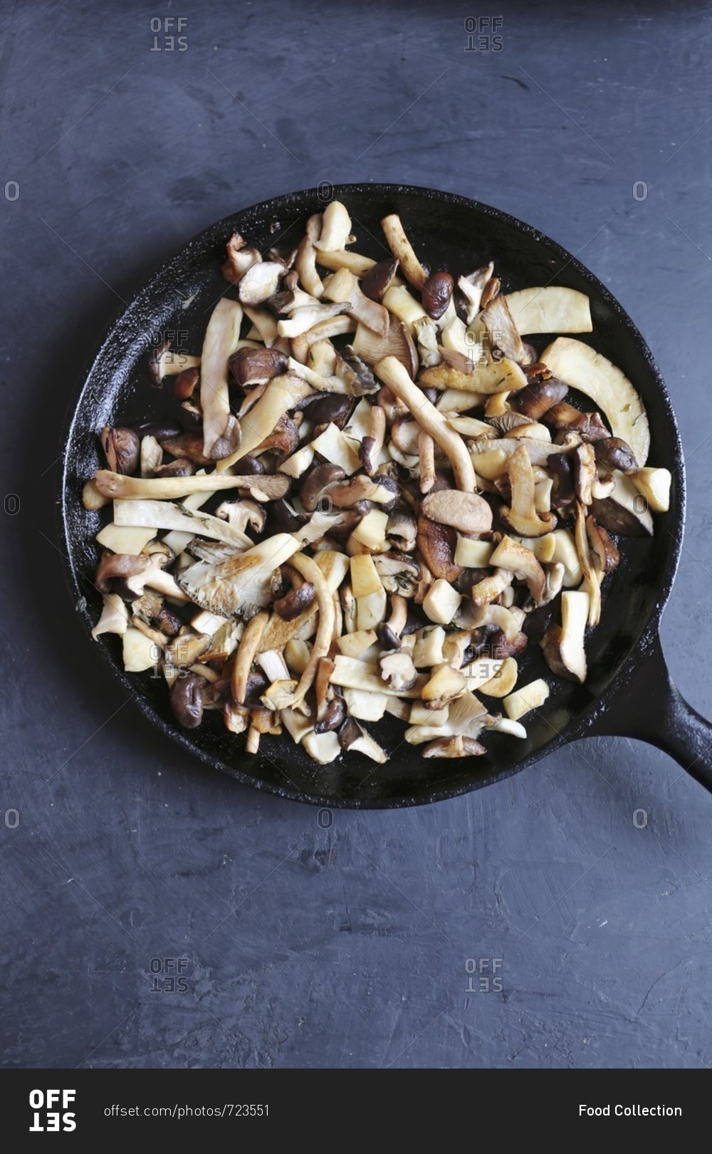 A pan on mixed mushrooms including king trumpet, piopinni, maitake
