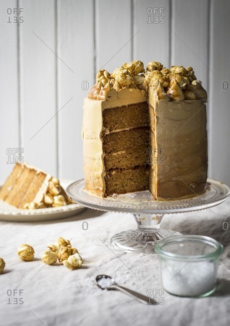 Salted caramel cake topped with popcorn, sliced