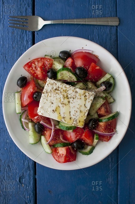 Greek salad with tomatoes, cucumber, onions, black olives, feta cheese, olive oil and dried oregano