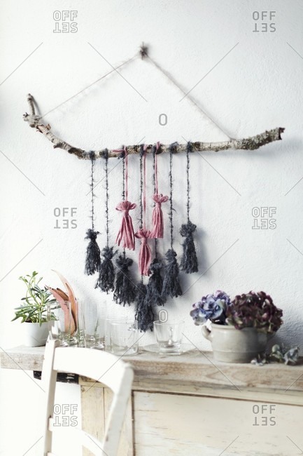 Wall decoration made from birch branch and tassels hand-made from wool remnants