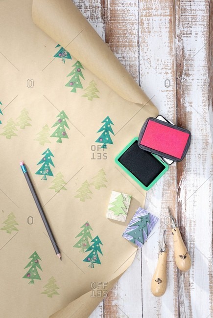 Hand-crafted wrapping paper made from brown paper printed with pattern of Christmas trees