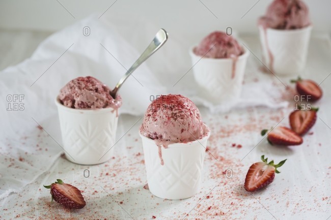 Homemade strawberry ice cream in tubs