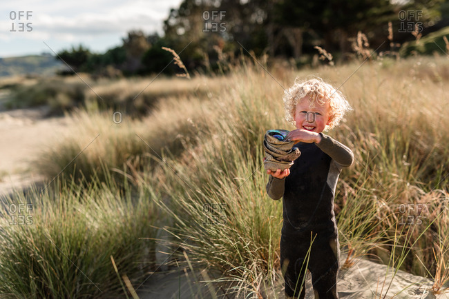 Boy gathering paua shells on Hawke's Bay, New Zealand