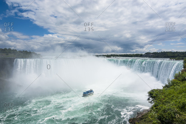 Tourist boat in the mist of the Horseshoe Falls (Canadian Falls), Niagara Falls, Ontario, Canada, North America