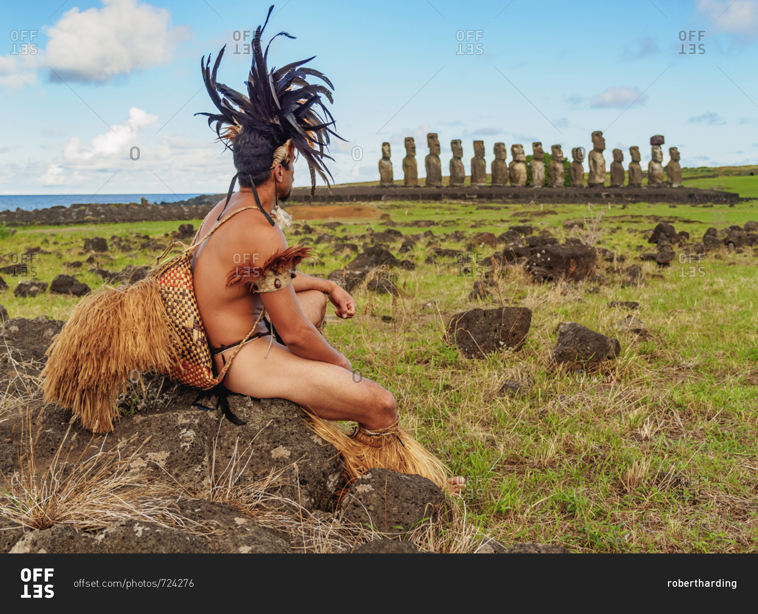 Native Rapa Nui man in traditional costume and Moais in Ahu Tongariki, Rapa Nui National Park, UNESCO World Heritage Site, Easter Island, Chile, South America