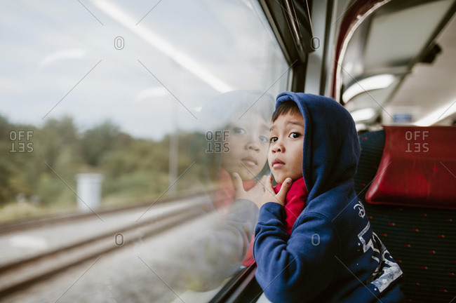 Boy watching the scenery out of train window