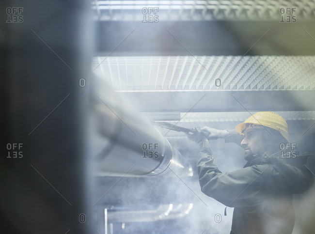 Mechanic fixing pipework with gaspipe pliers